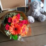 hand bouquet orange gerbera red roses
