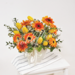 table-flower-arrangement-orange-gerbera-yellow-tulip